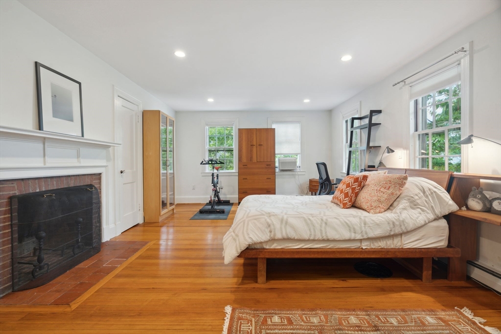 172 Bellevue Road Watertown, MA 02472 - Photo 20 of 34 a bedroom with a bed and a fireplace