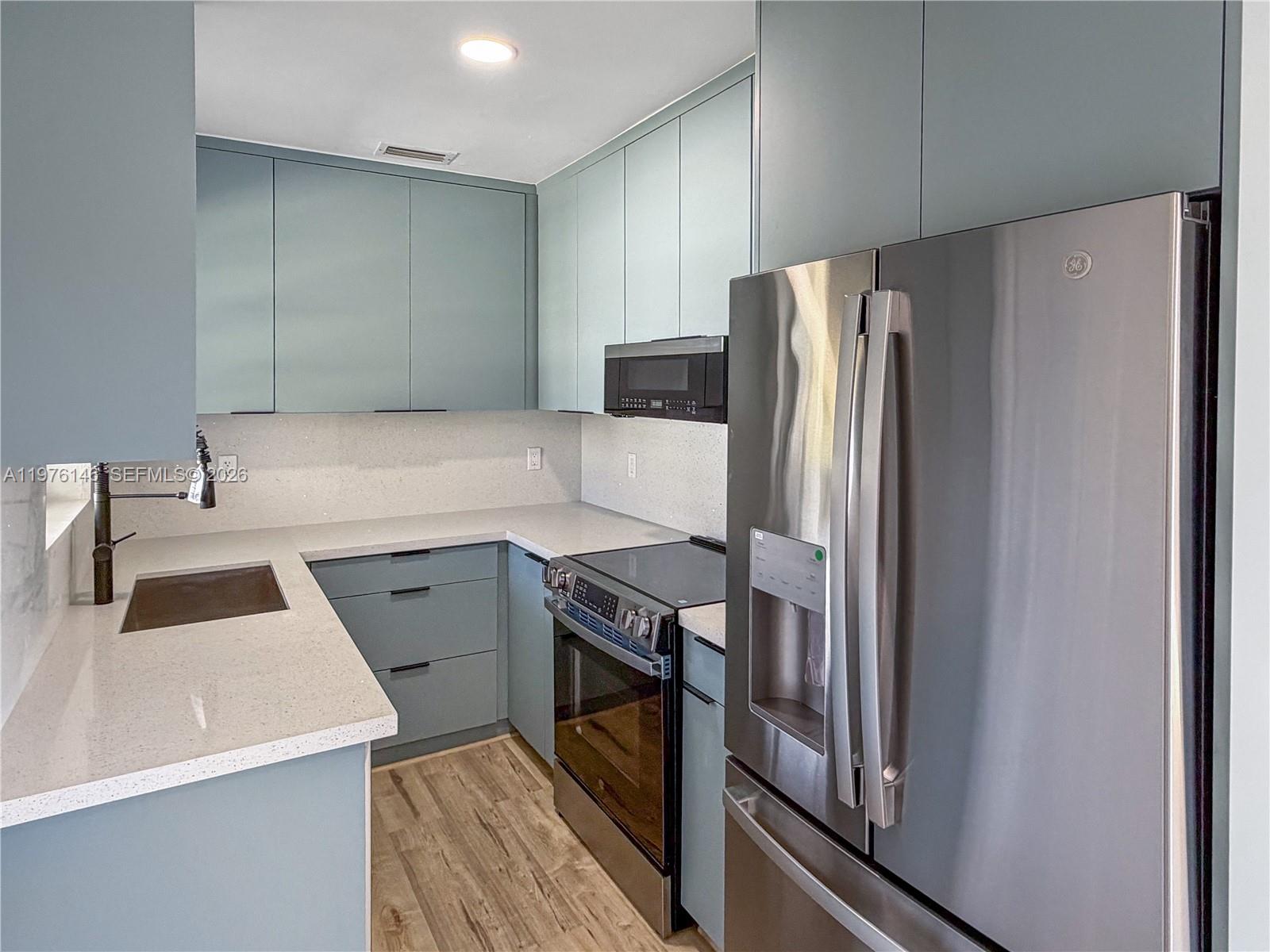 5245 Southwest 98th Court Miami, FL 33165 - Photo 2 of 22 a kitchen with a refrigerator sink and stove