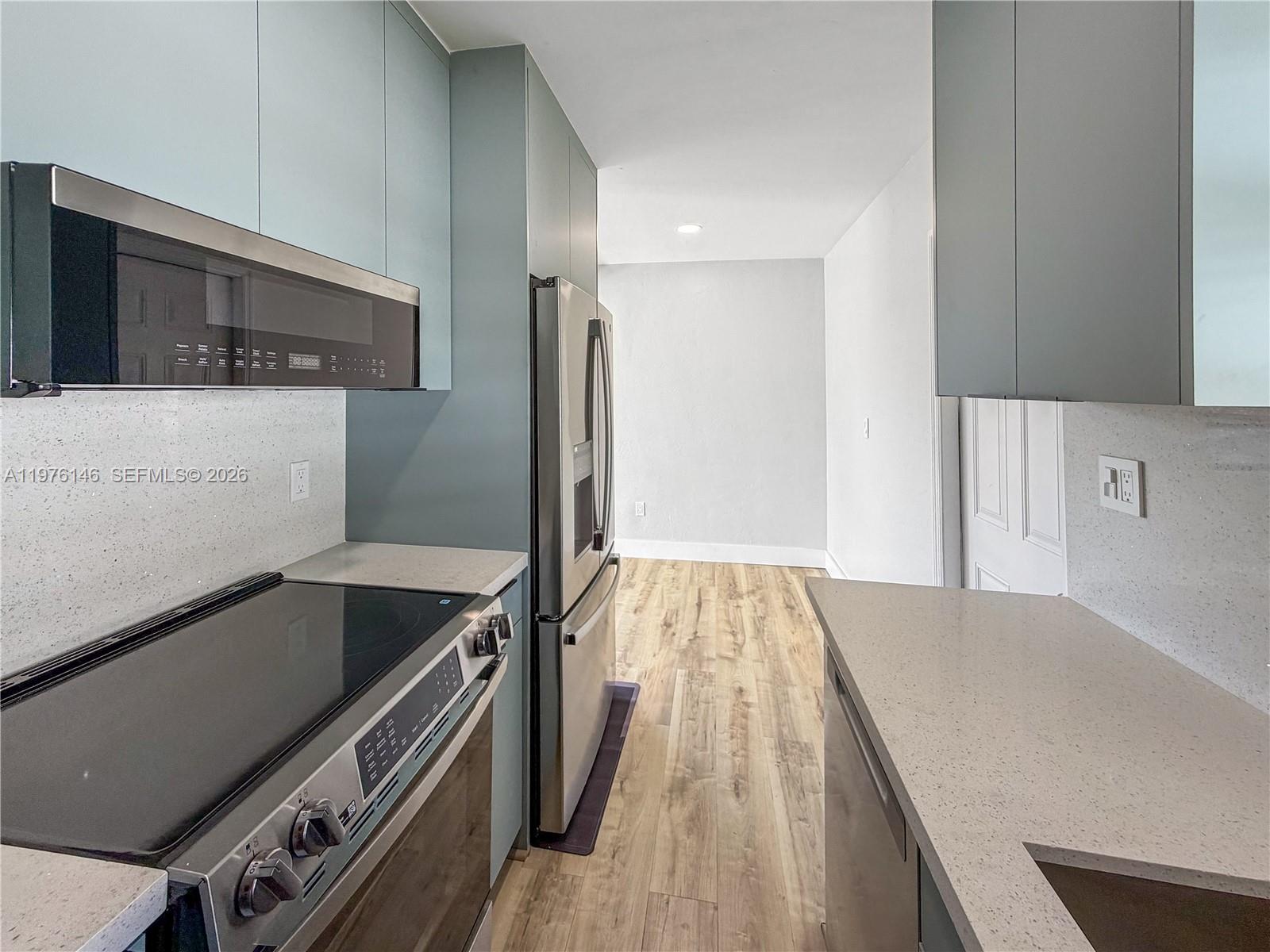 5245 Southwest 98th Court Miami, FL 33165 - Photo 4 of 22 a kitchen with a stove and a refrigerator