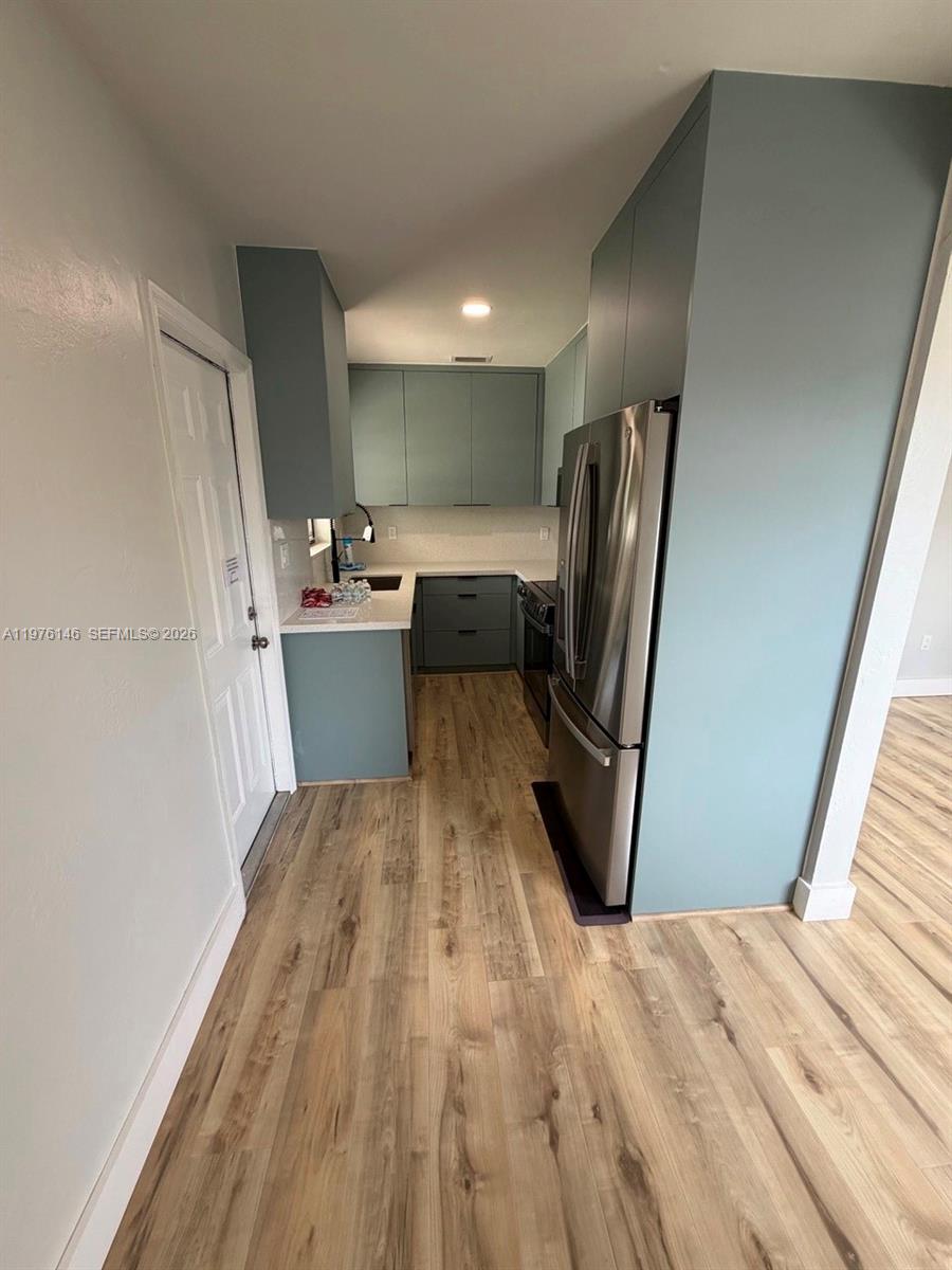 5245 Southwest 98th Court Miami, FL 33165 - Photo 5 of 22 a view of kitchen with refrigerator stove and wooden floor