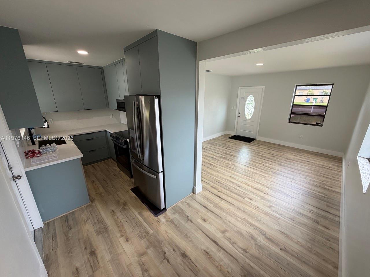 5245 Southwest 98th Court Miami, FL 33165 - Photo 6 of 22 a view of a refrigerator in kitchen and wooden floor