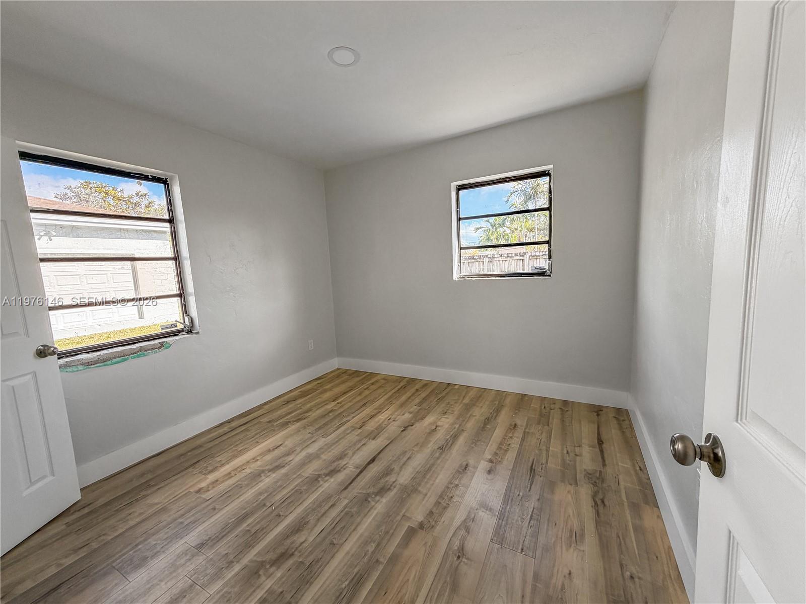 5245 Southwest 98th Court Miami, FL 33165 - Photo 9 of 22 a view of an empty room with wooden floor and a window