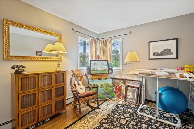 a view of a workspace with furniture and a window