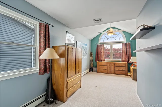 a view of a bedroom with furniture and a window