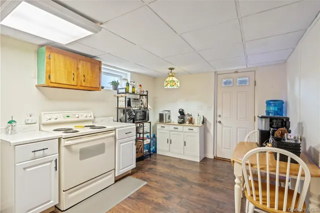a kitchen with cabinets and wooden floor