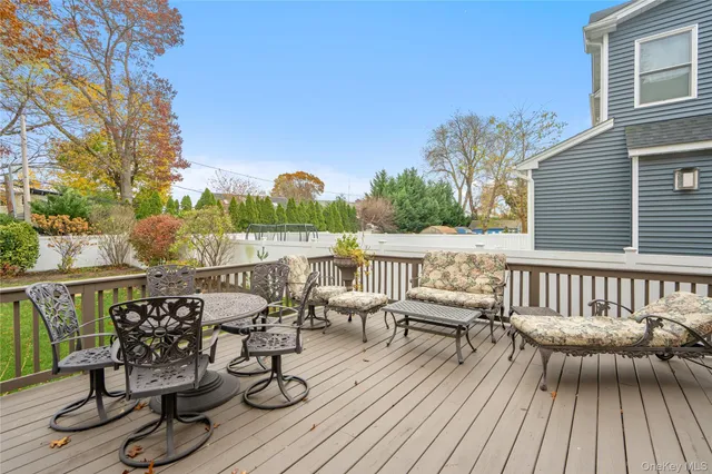 a view of a balcony with chairs and wooden floor