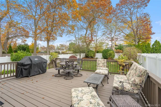 a view of a patio with table and chairs and wooden floor