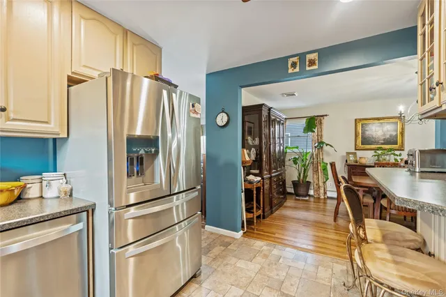 a kitchen with stainless steel appliances granite countertop a refrigerator and a sink