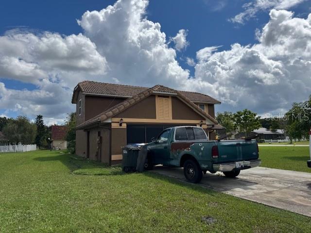 2457 Ravendale Court Kissimmee, FL 34758 - Photo 2 of 17 a car parked in front of a house and a yard