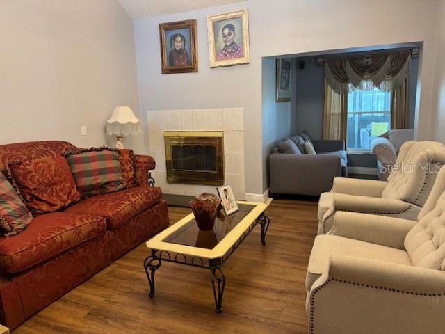 2457 Ravendale Court Kissimmee, FL 34758 - Photo 4 of 17 a living room with furniture and a fireplace