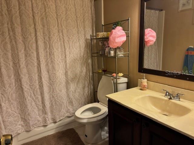 2457 Ravendale Court Kissimmee, FL 34758 - Photo 9 of 17 a bathroom with a sink vanity mirror and toilet