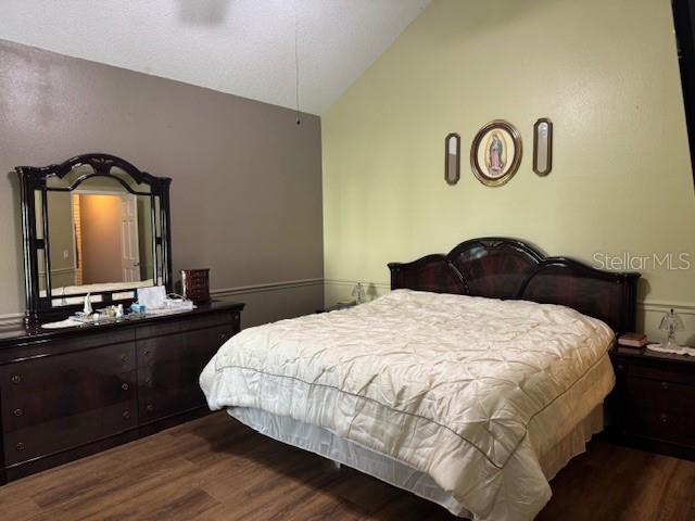 2457 Ravendale Court Kissimmee, FL 34758 - Photo 10 of 17 a bedroom with a bed and a mirror