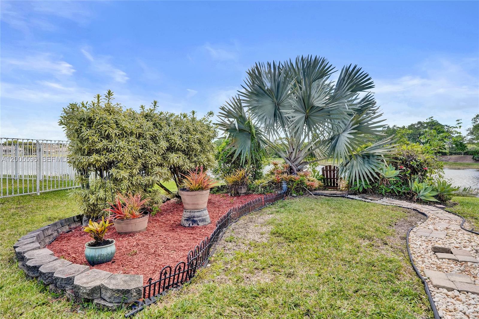 4281 Laurel Ridge Circle Weston, FL 33331 - Photo 69 of 80 a view of a backyard with plants and lake view