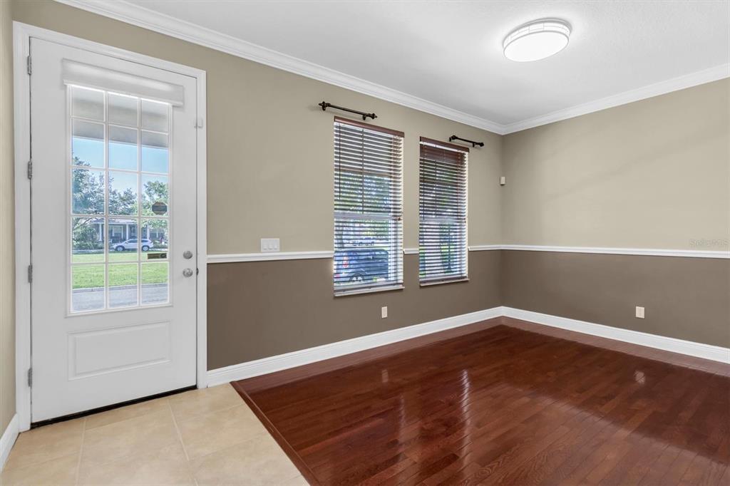 10121 Porch Street New Port Richey, FL 34655 - Photo 5 of 57 a view of an empty room with wooden floor and a window