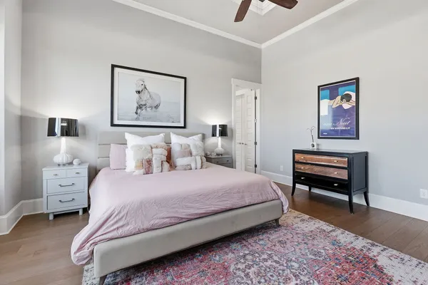 a bedroom with a bed and a painting on the wall