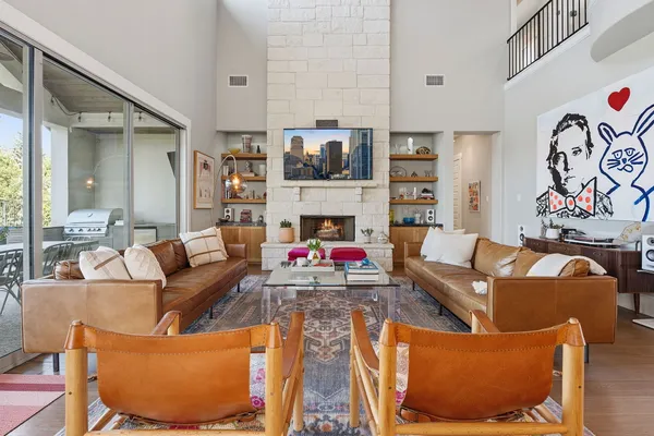 a living room with fireplace furniture and a wooden floor