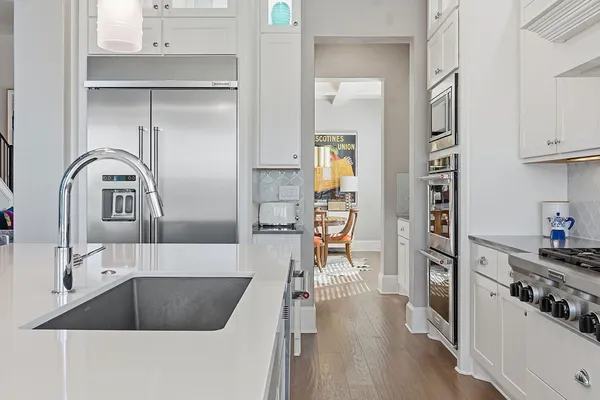 a kitchen with cabinets and a wooden floor