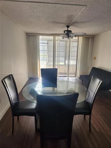 a kitchen with stainless steel appliances a sink window and cabinets