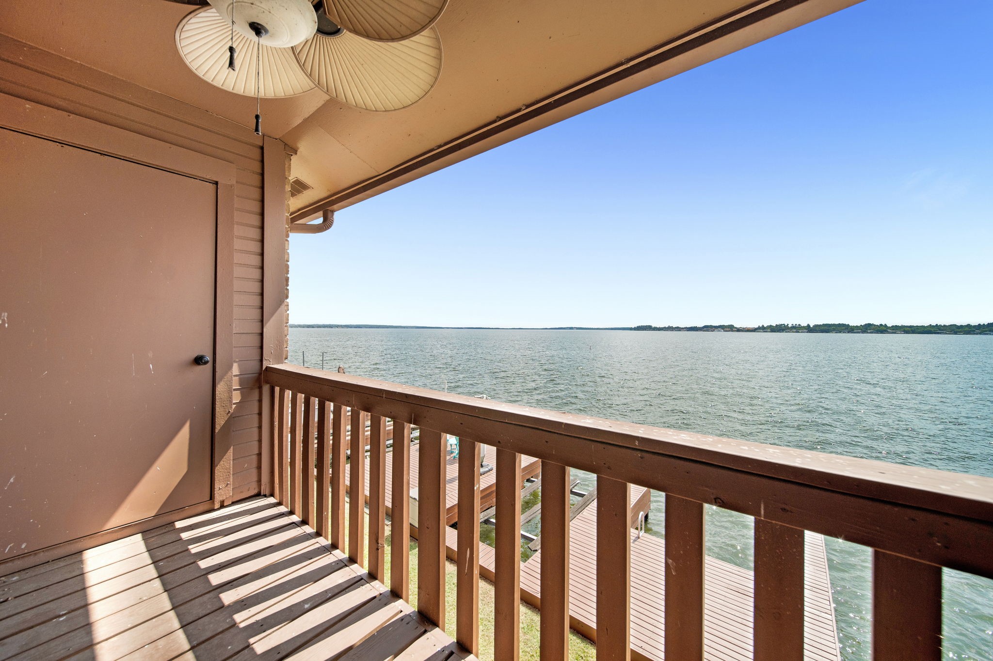 801 River Road, Unit E 116 Montgomery, TX 77356 - Photo 11 of 14 back balcony view of the lake and space for seating.