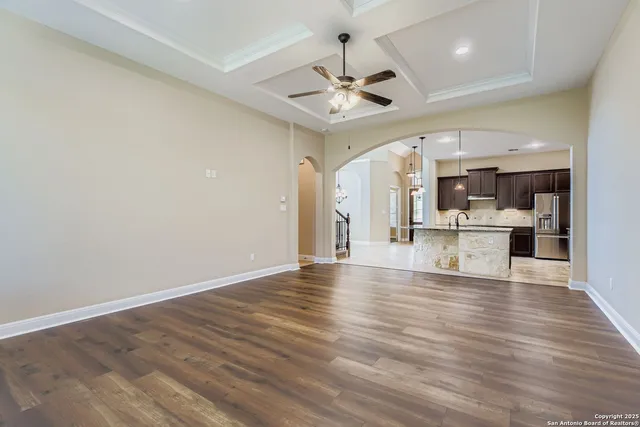 a view of a kitchen with wooden floor and a kitchen island