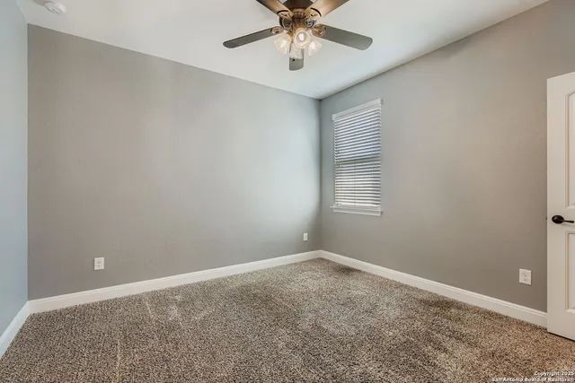 a view of room with window and ceiling fan