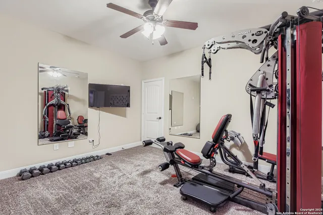 a bathroom with a granite countertop sink toilet and mirror