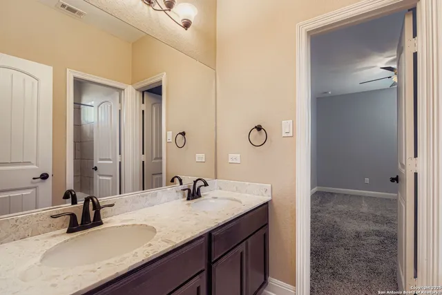 a bathroom with a toilet a sink and mirror