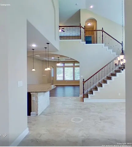 a view of staircase and hall with windows