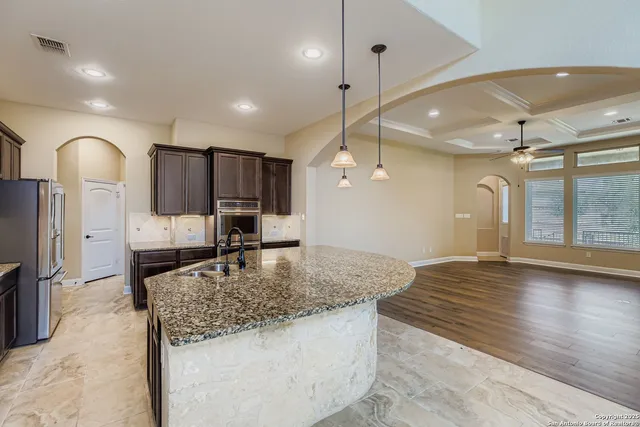 a kitchen with a refrigerator a sink and a counter top space