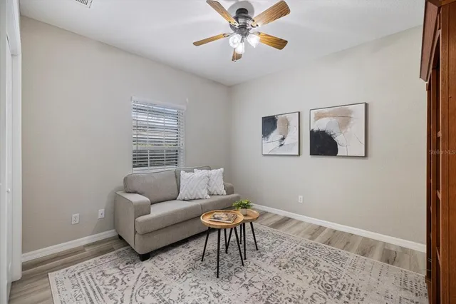 a spacious bedroom with a bed and a chandelier