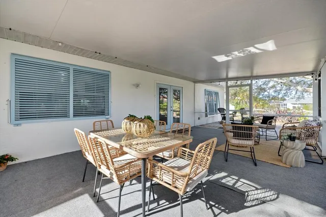 a view of a chairs and table in backyard of the house