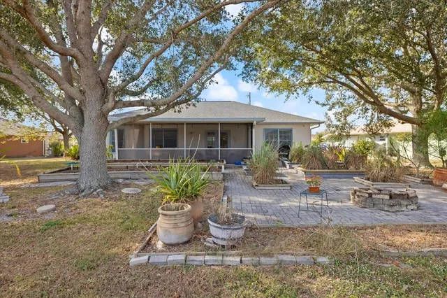 a view of a patio with table and chairs under an umbrella