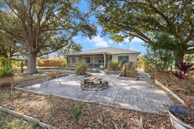 a view of a house with a yard and sitting area
