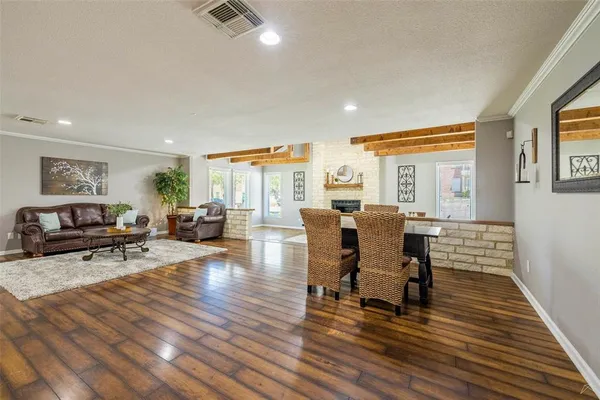 a living room with furniture and wooden floor