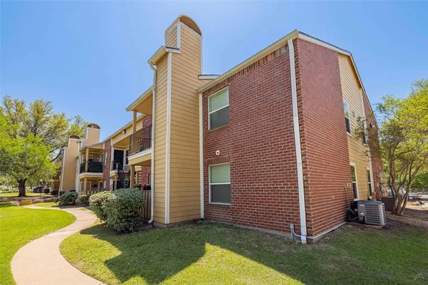 a backyard of a house with yard and outdoor seating