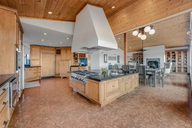 a kitchen with stainless steel appliances granite countertop a stove and a refrigerator