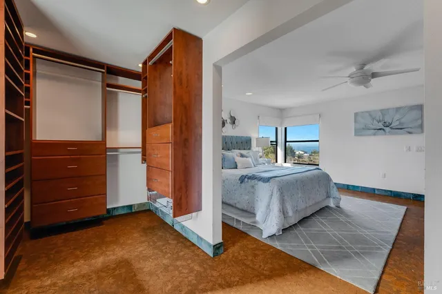 a view of room with walk in closet and bedroom