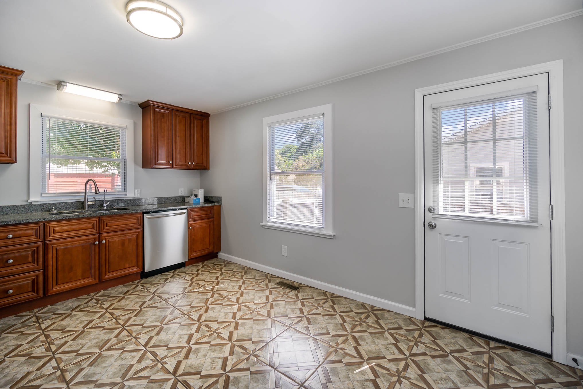 106 Jordan Avenue Mount Pleasant, TN 38474 - Photo 15 of 30 a kitchen with granite countertop a stove a sink and a window
