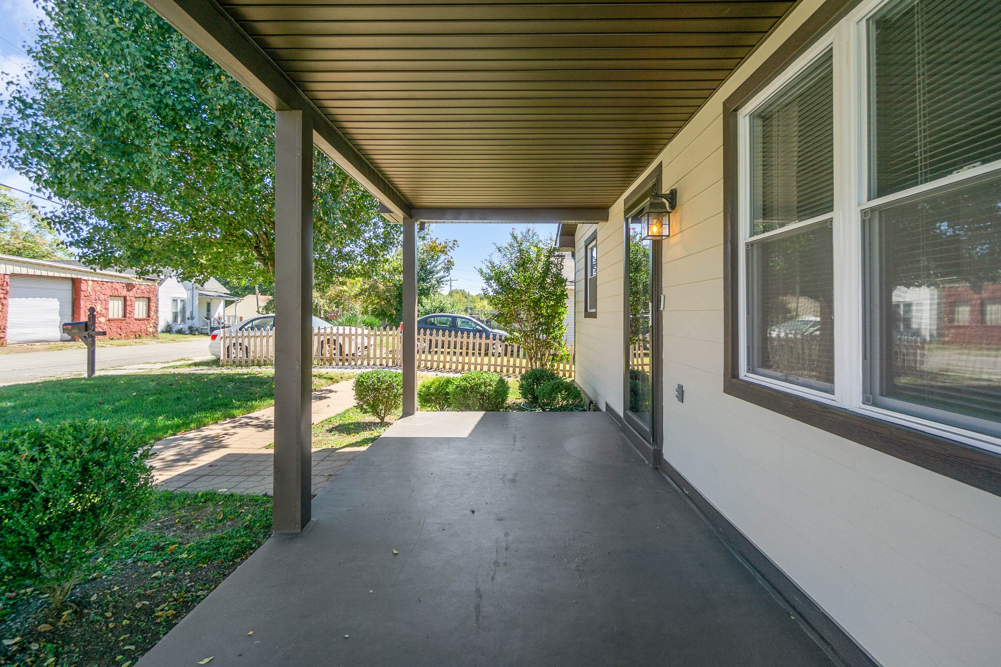 106 Jordan Avenue Mount Pleasant, TN 38474 - Photo 5 of 30 a view of a porch with a table chairs potted plants and a large tree