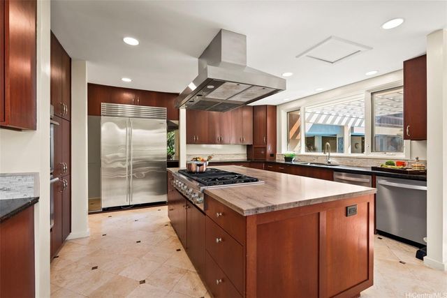a kitchen with stainless steel appliances granite countertop a stove and a sink