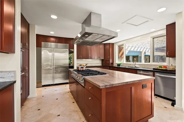 a kitchen with stainless steel appliances granite countertop a stove and a sink