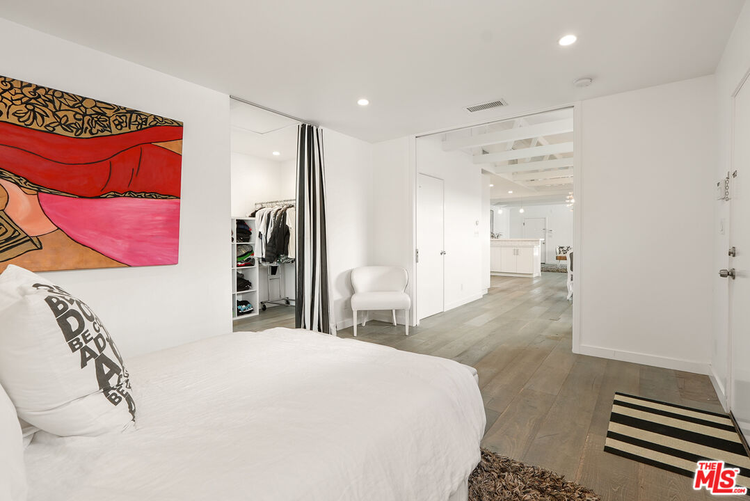 754 Washington Boulevard Marina del Rey, CA 90292 - Photo 9 of 16 a bedroom with a large bed and a chandelier