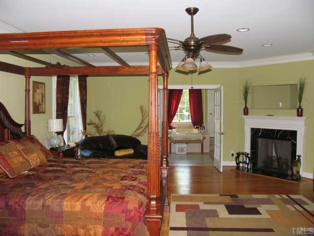 30 Piney Grove Road Bahama, NC 27503 - Photo 5 of 12 Opulent master bedroom with fireplace and french doors that open to large, well appointed, master bath. Master Bedroom