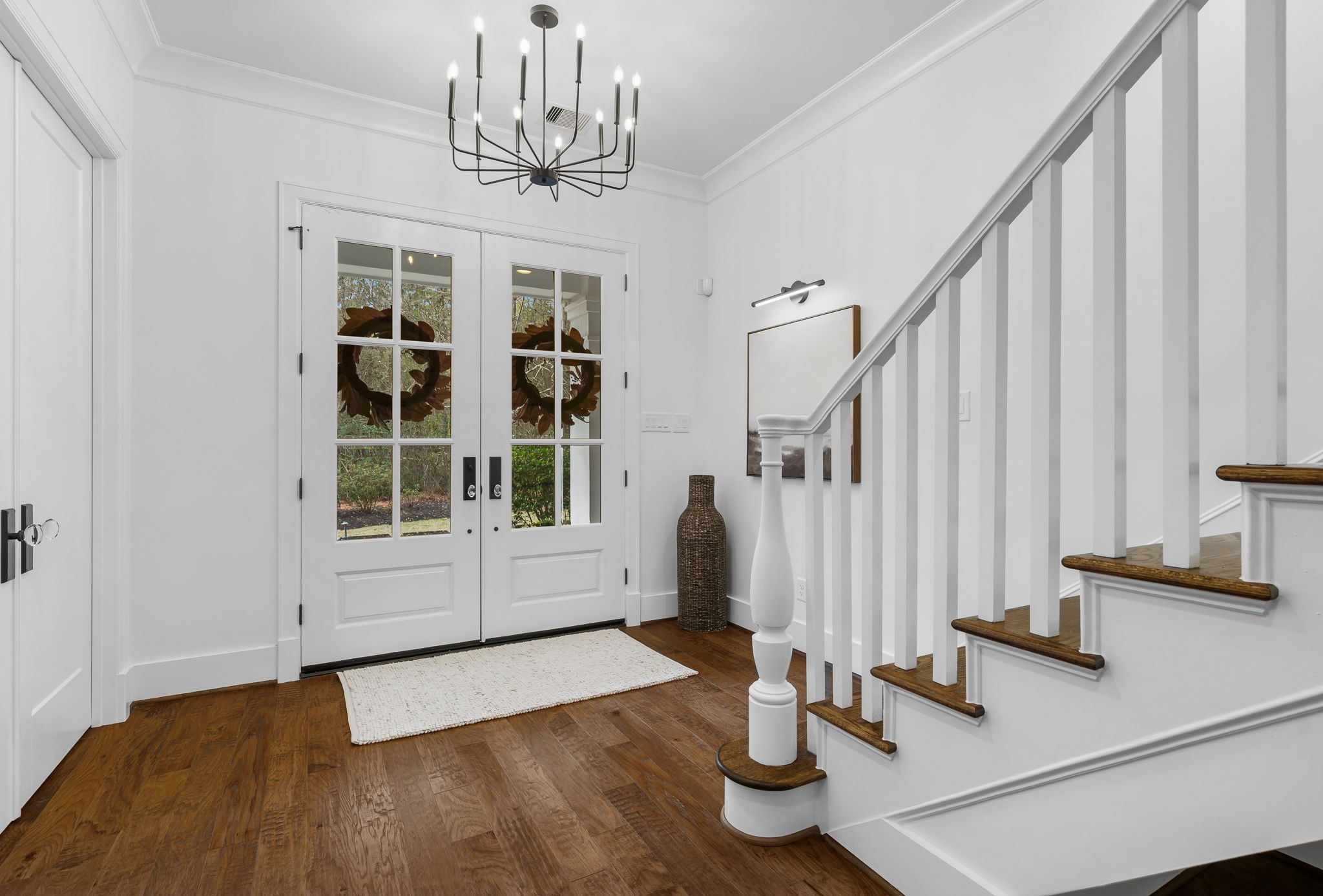 10 Riata Drive Magnolia, TX 77354 - Photo 15 of 48 Some of this home's many fine feature's include Shaw distressed hand scraped hardwood floors, Level 5 drywall in a light color palette, LED lighting, extensive millwork, built-in bookcases, solid core doors and glass vintage-style door knobs throughout.