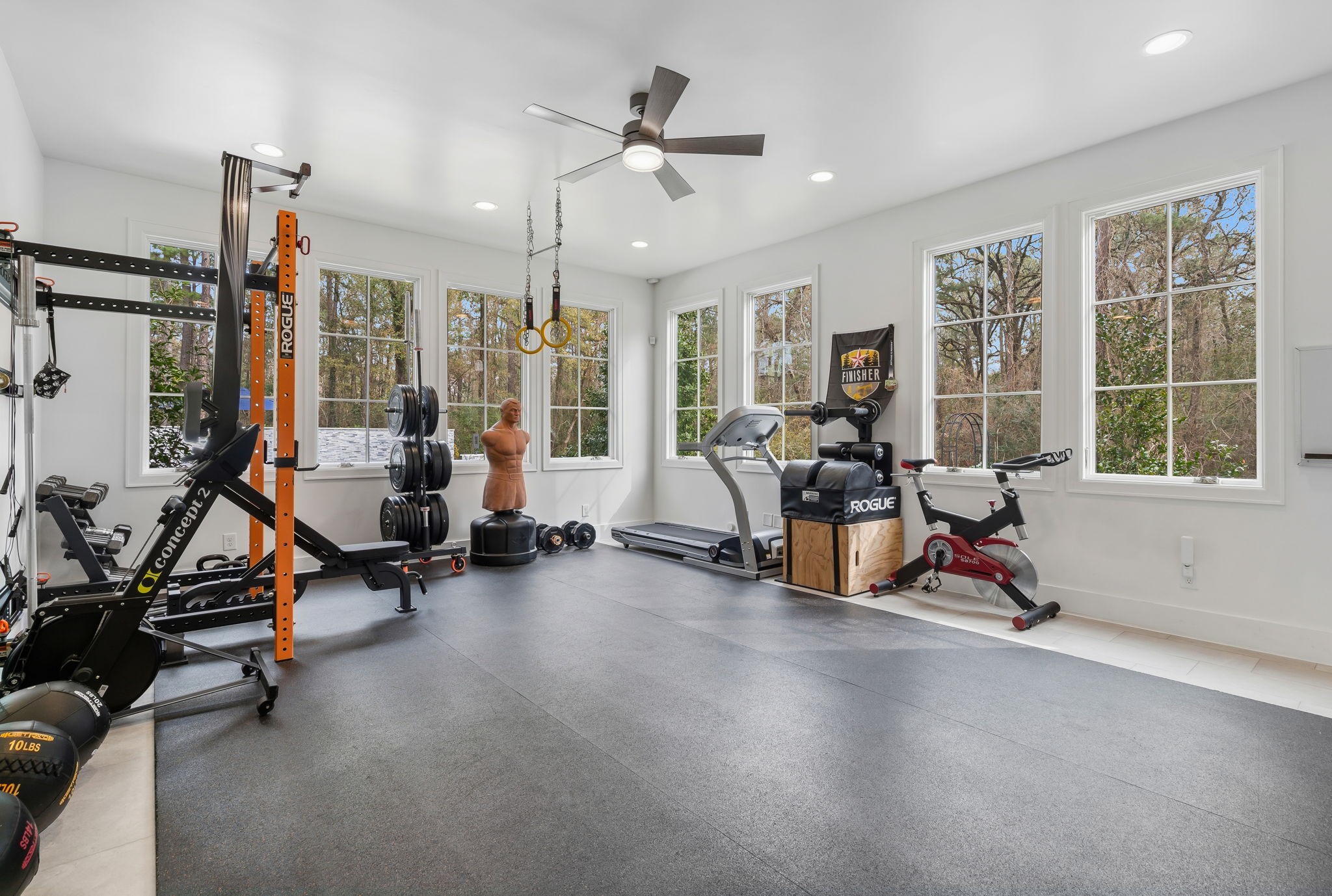 10 Riata Drive Magnolia, TX 77354 - Photo 25 of 48 Bathed in abundant natural light, this HUGE 18x22 flex room, with mini-split wall ac unit, is being used as a gym. It could also serve as another bedroom, a study or a homeschool, craft/hobby room. See virtual rendering of a bedroom in the next photo.