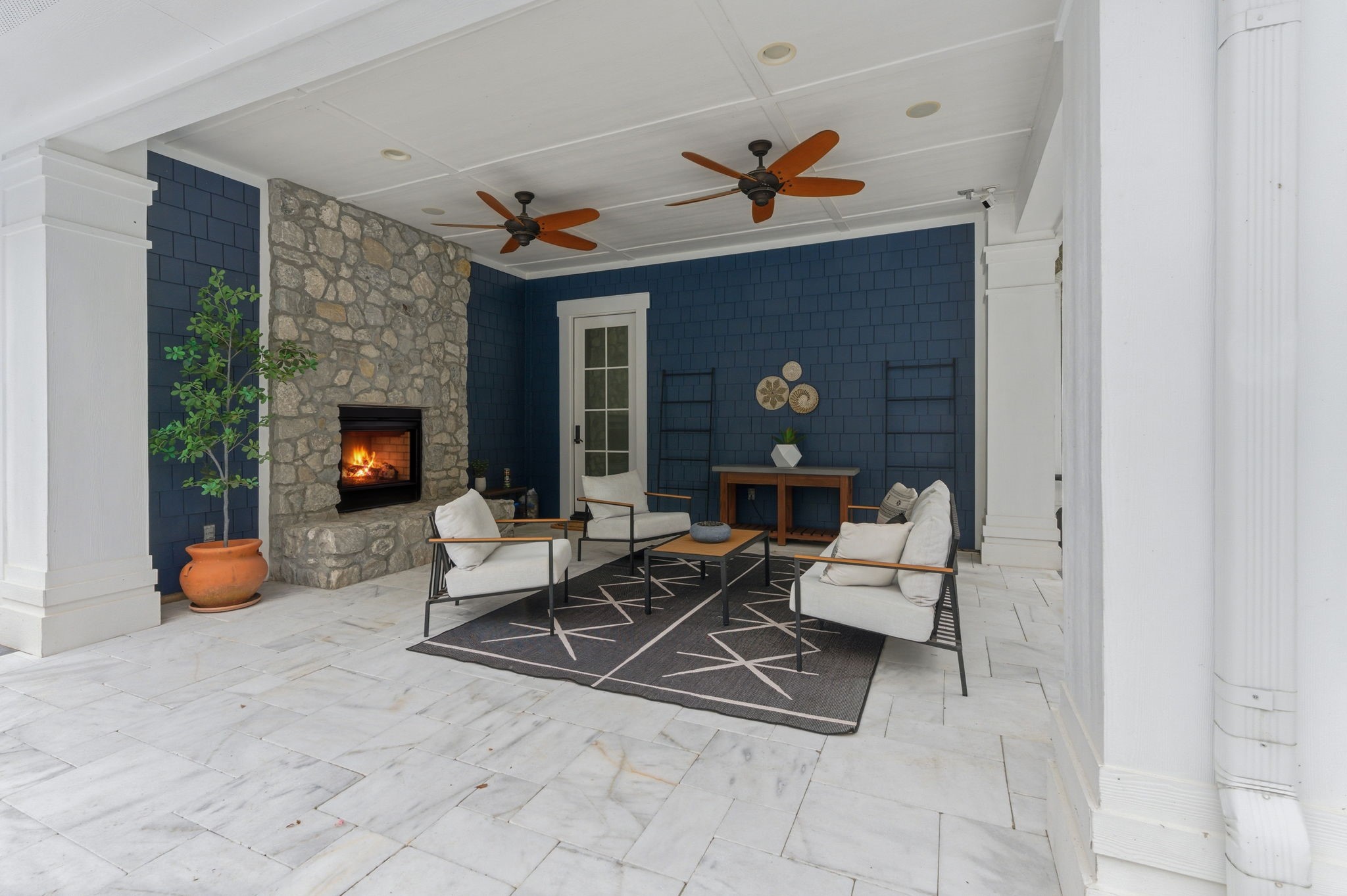 10 Riata Drive Magnolia, TX 77354 - Photo 36 of 48 The covered porch off the back of the house boasts a charming stone dual-sided gas fireplace, surround sound, ceiling fans and marble tile floor. Its a perfect spot to kick back and relax!