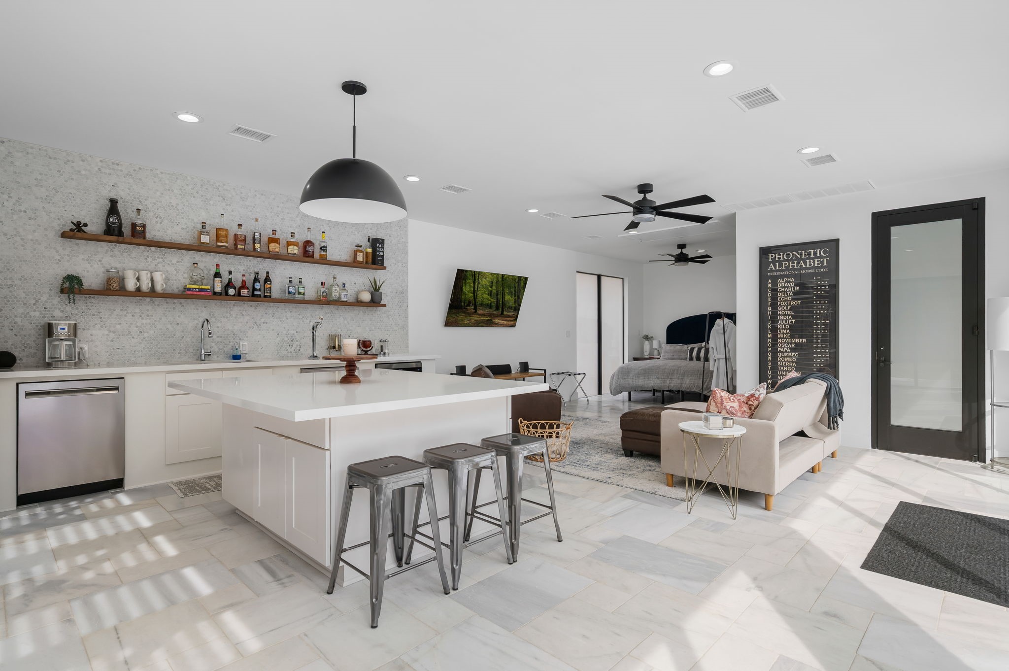 10 Riata Drive Magnolia, TX 77354 - Photo 8 of 48 Kitchen features indoor sink with disposal, dishwasher, built-in microwave, kegerator, and refrigerator connection. Outdoors the summer kitchen features 38" Bull grill plus a dual burner. Door on right side opens to a full bath. A king size bed with mounted headboard is tucked away in the corner. A barn door could be added for additional privacy.