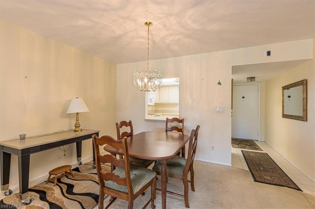 5483 Rattlesnake Hammock Road, Unit B201 Naples, FL 34113 - Photo 8 of 22 a dining room with furniture and window