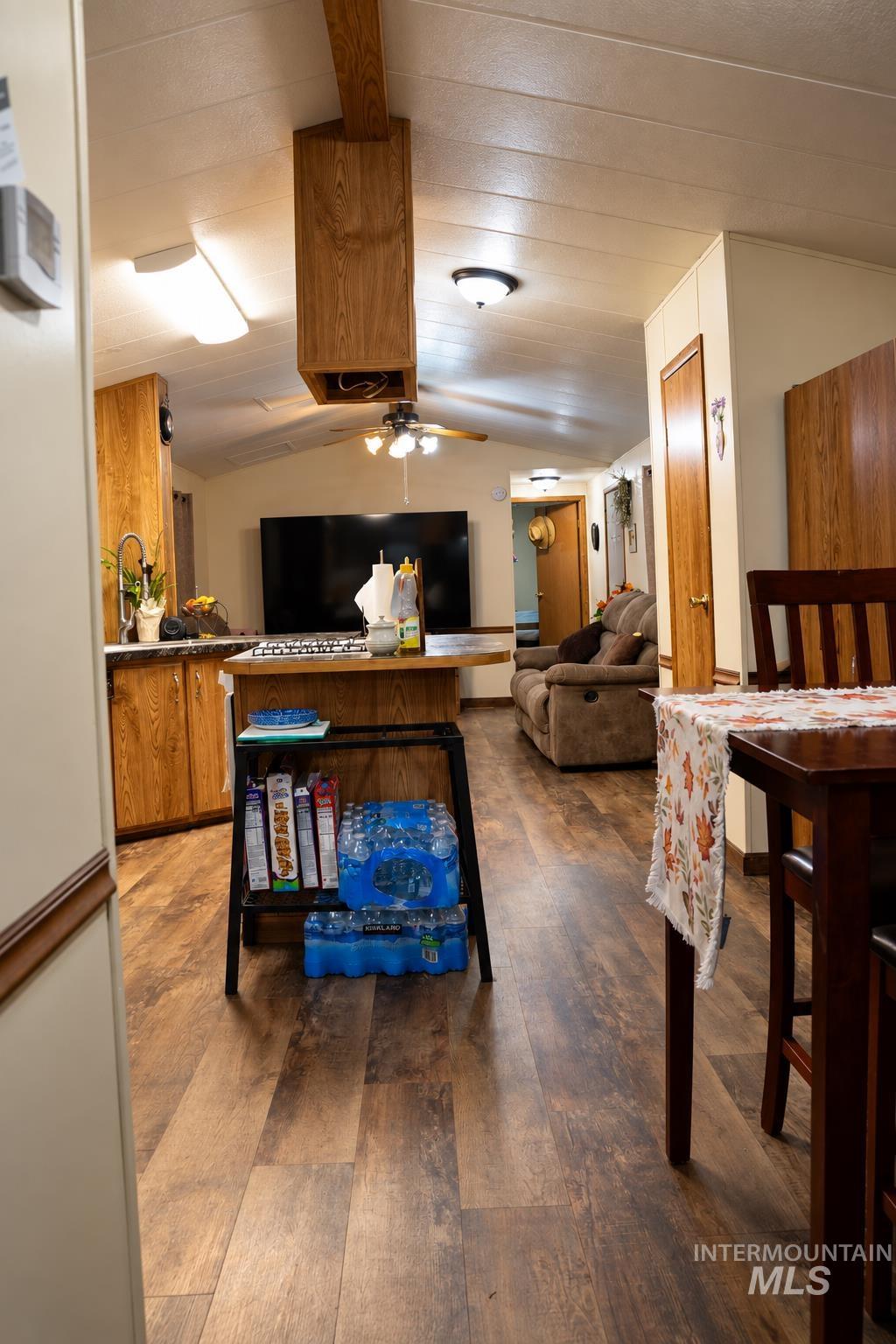 198 South Hills Road, Unit 52 Twin Falls, ID 83301 - Photo 8 of 22 Wood-finish flooring throughout, vaulted ceiling, recessed and flush mount lighting, wood-finish cabinetry, and a ceiling fan