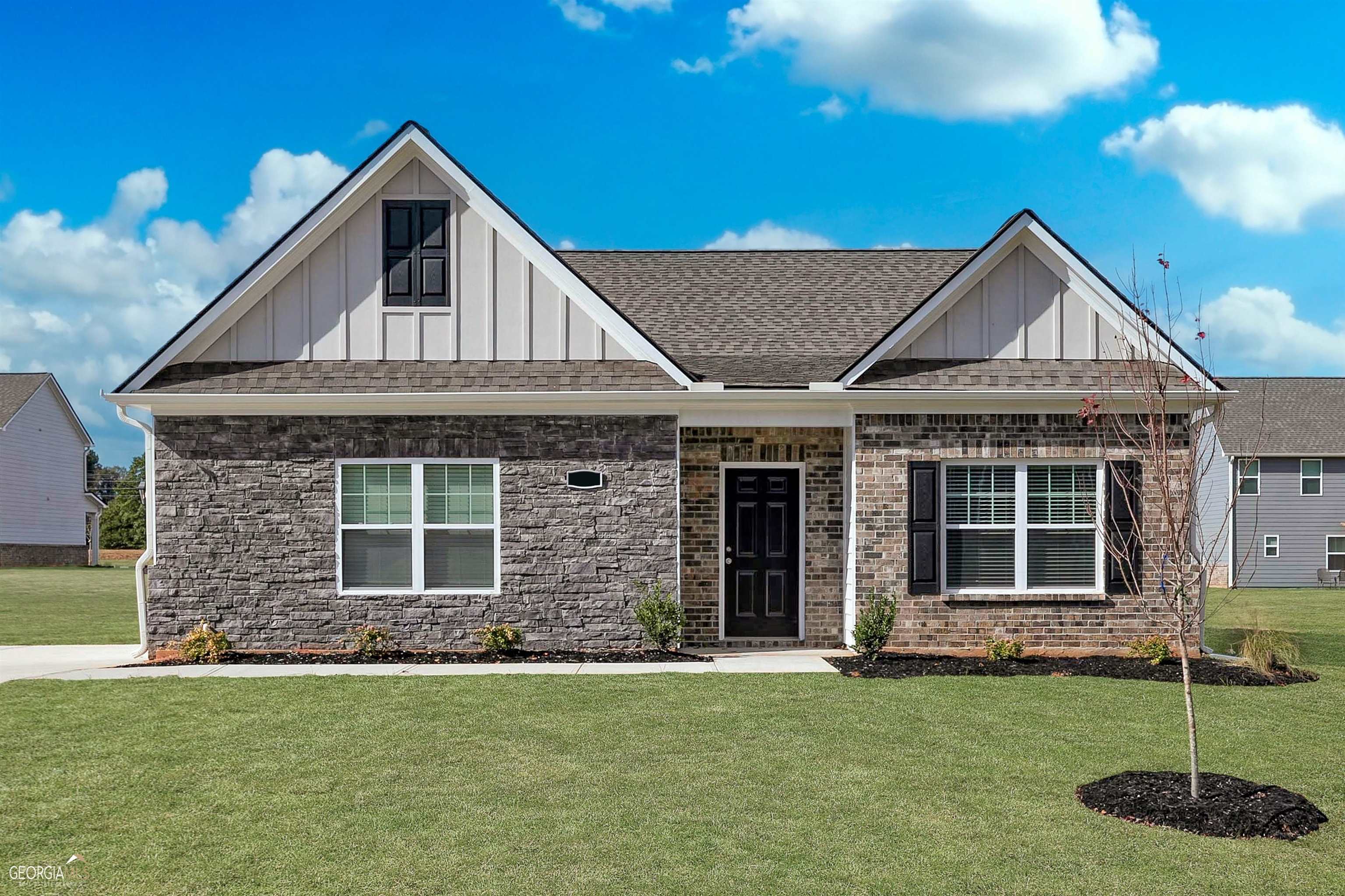a front view of a house with a garden